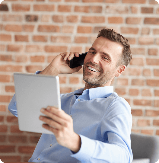 man-talking-phone-browsing-digital-tablet 1
